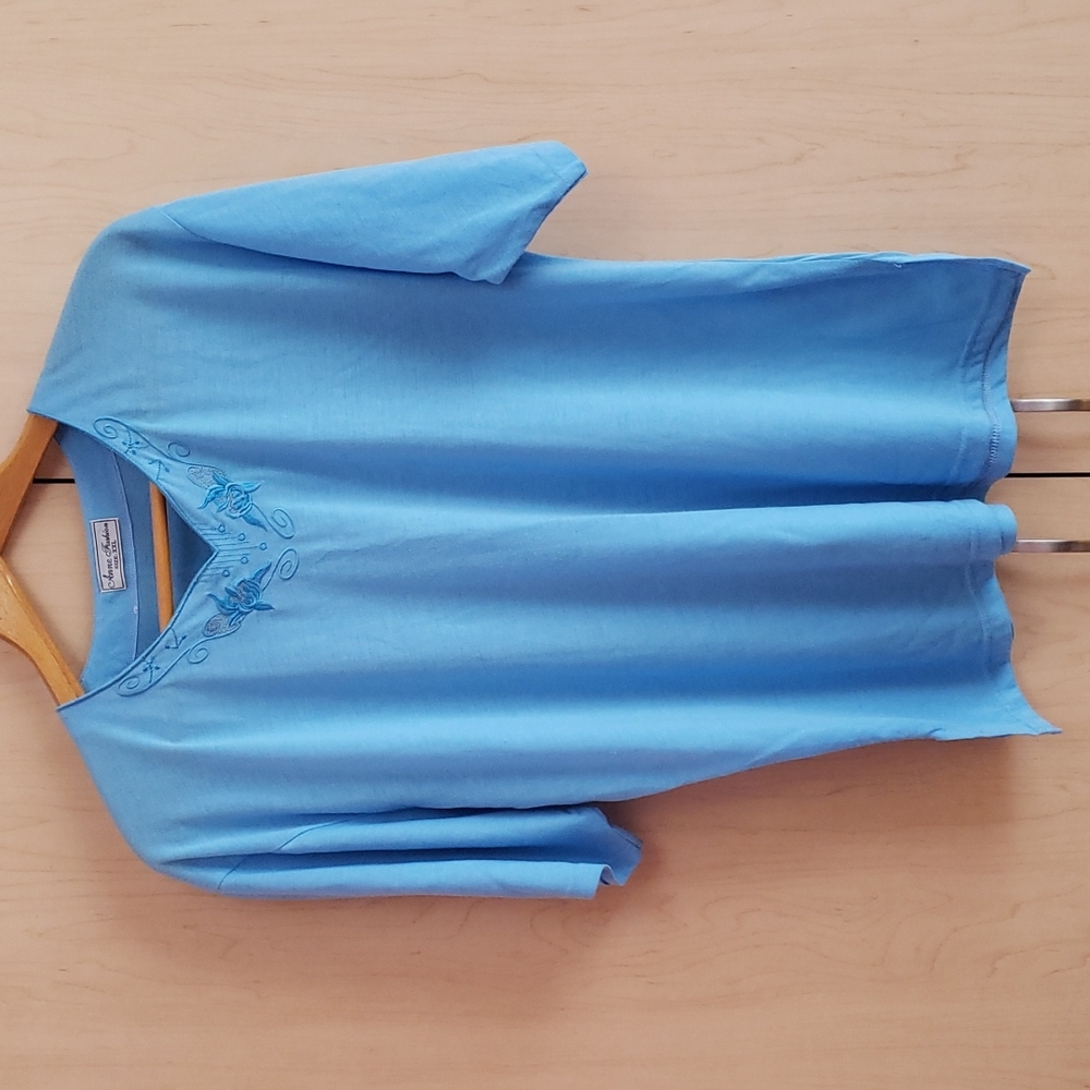 Light blue loose-fitting blouse with embroidered flowers